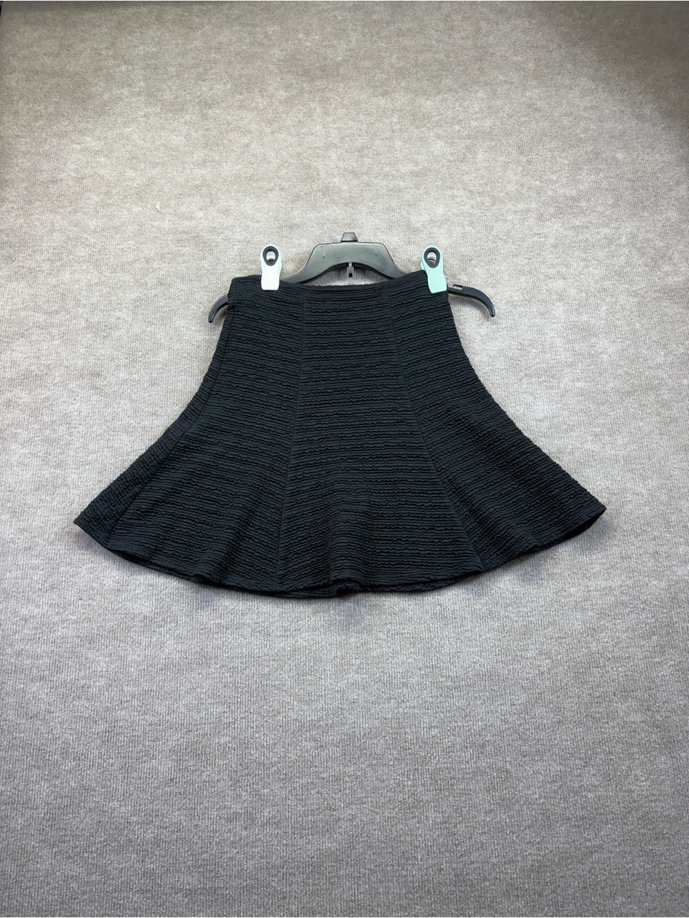Maeve black textured mini skirt features a high-waisted fit and a rear zip closu